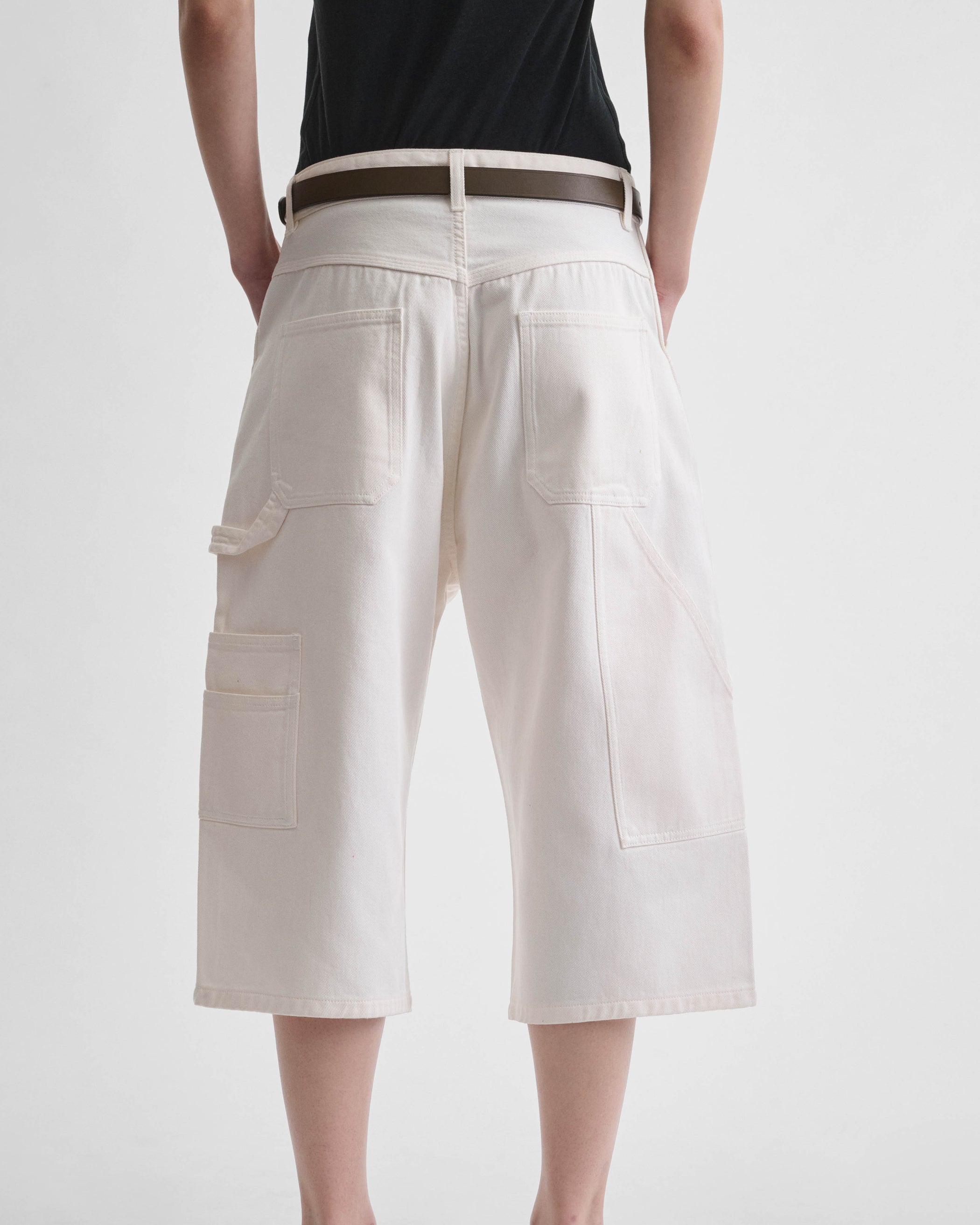 Back view of model wearing CARPENTER SHORTS in pale blush