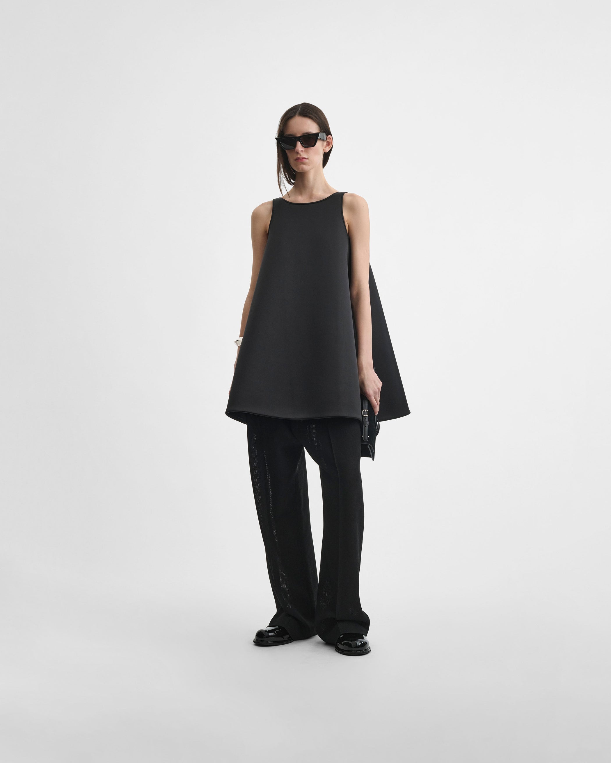 Front view of model wearing A TANK TOP in black silk