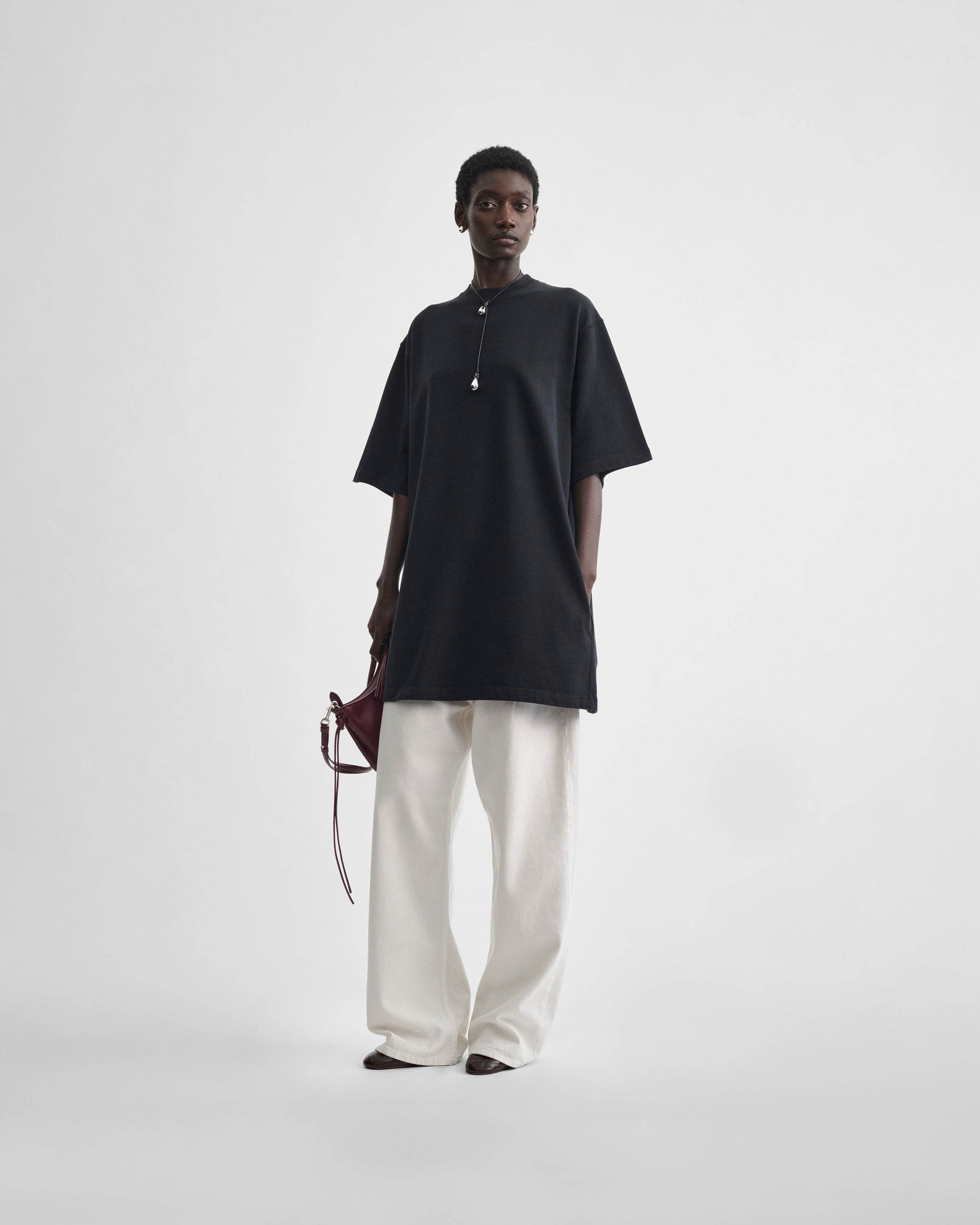 Full length front view of model wearing BIG T in black cotton