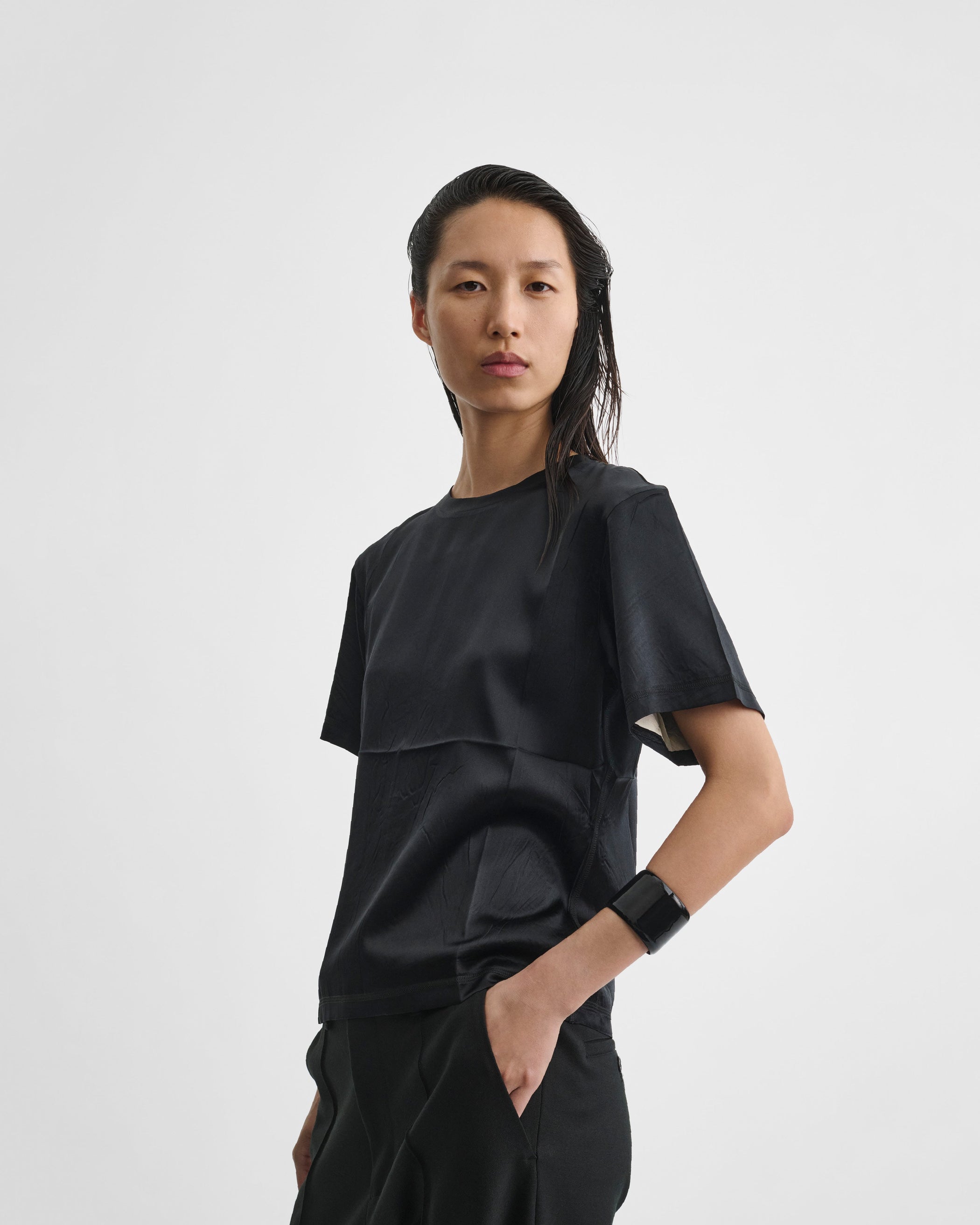 Angled front image of model wearing GRAPHIC T in black silk