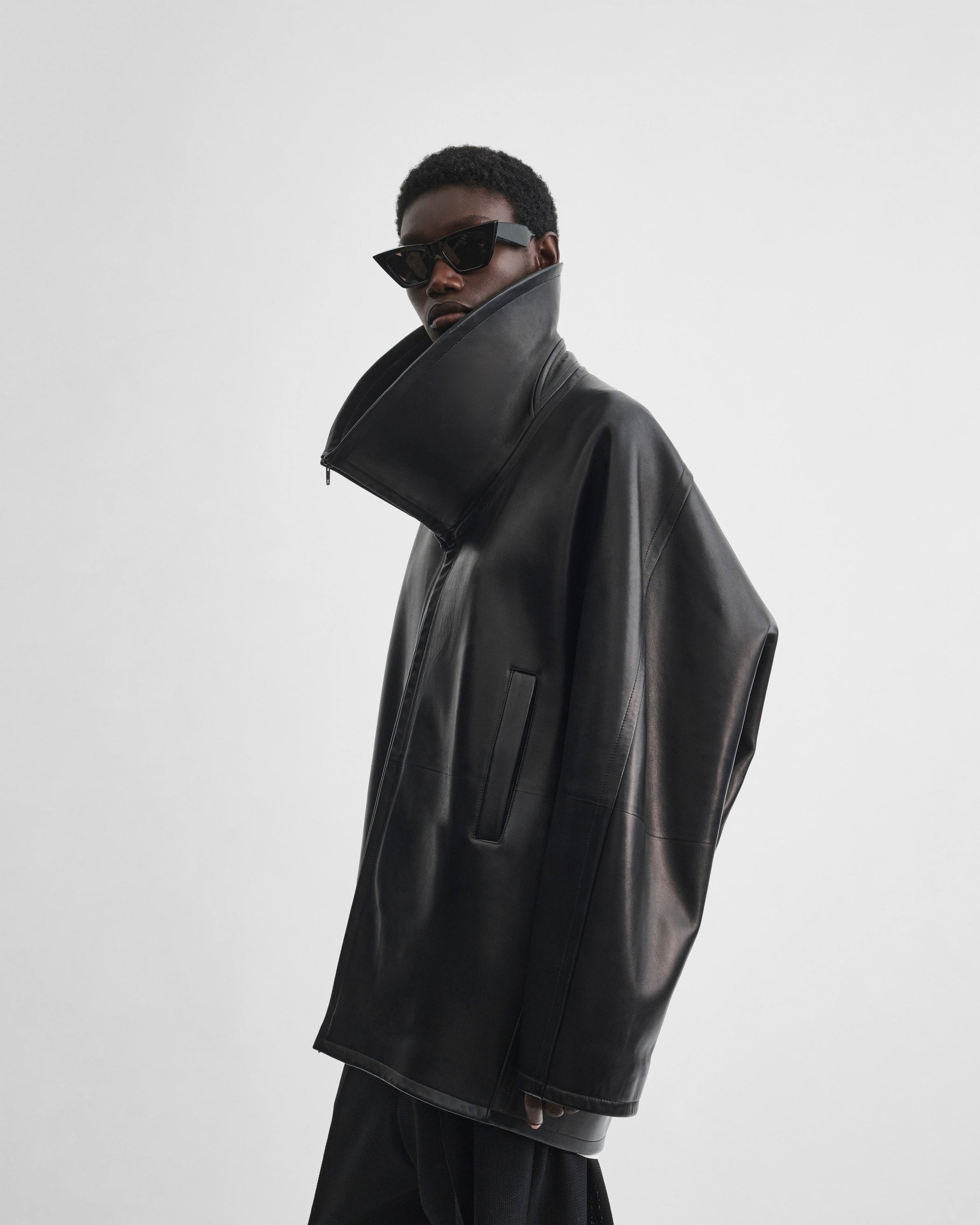 Angled front view of model wearing SWATHE JACKET in black leather