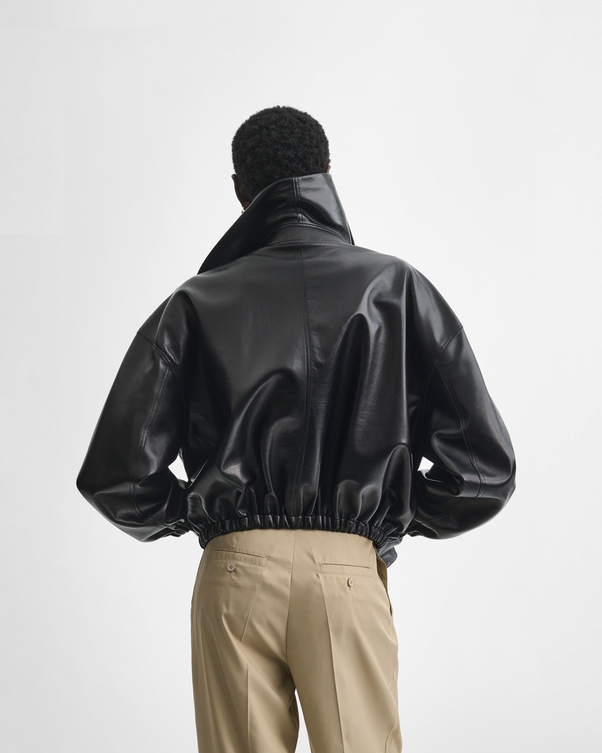 Back view of model wearing the MOON BOMBER in black leather